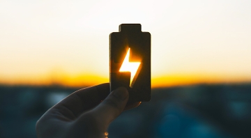 batería de vehículo eléctrico con atardecer de fondo