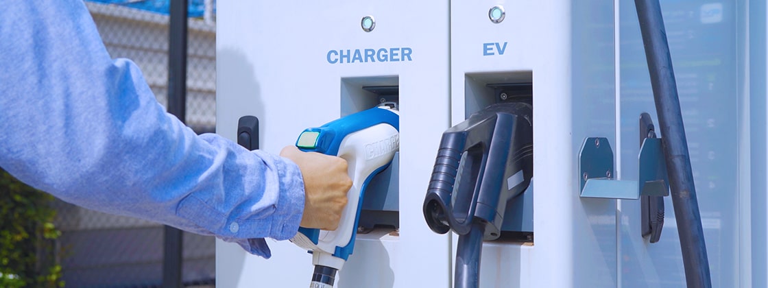 man at electric charging station