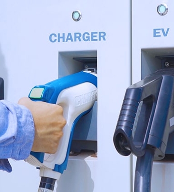 man at electric charging station