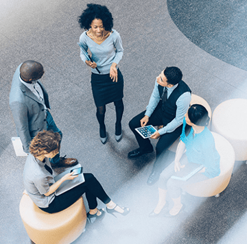 Mujer liderando un grupo de empleados diversos en discusión