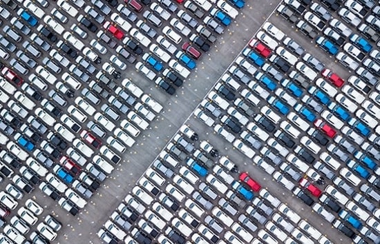 Row of hundreds of vehicles in a parking lot